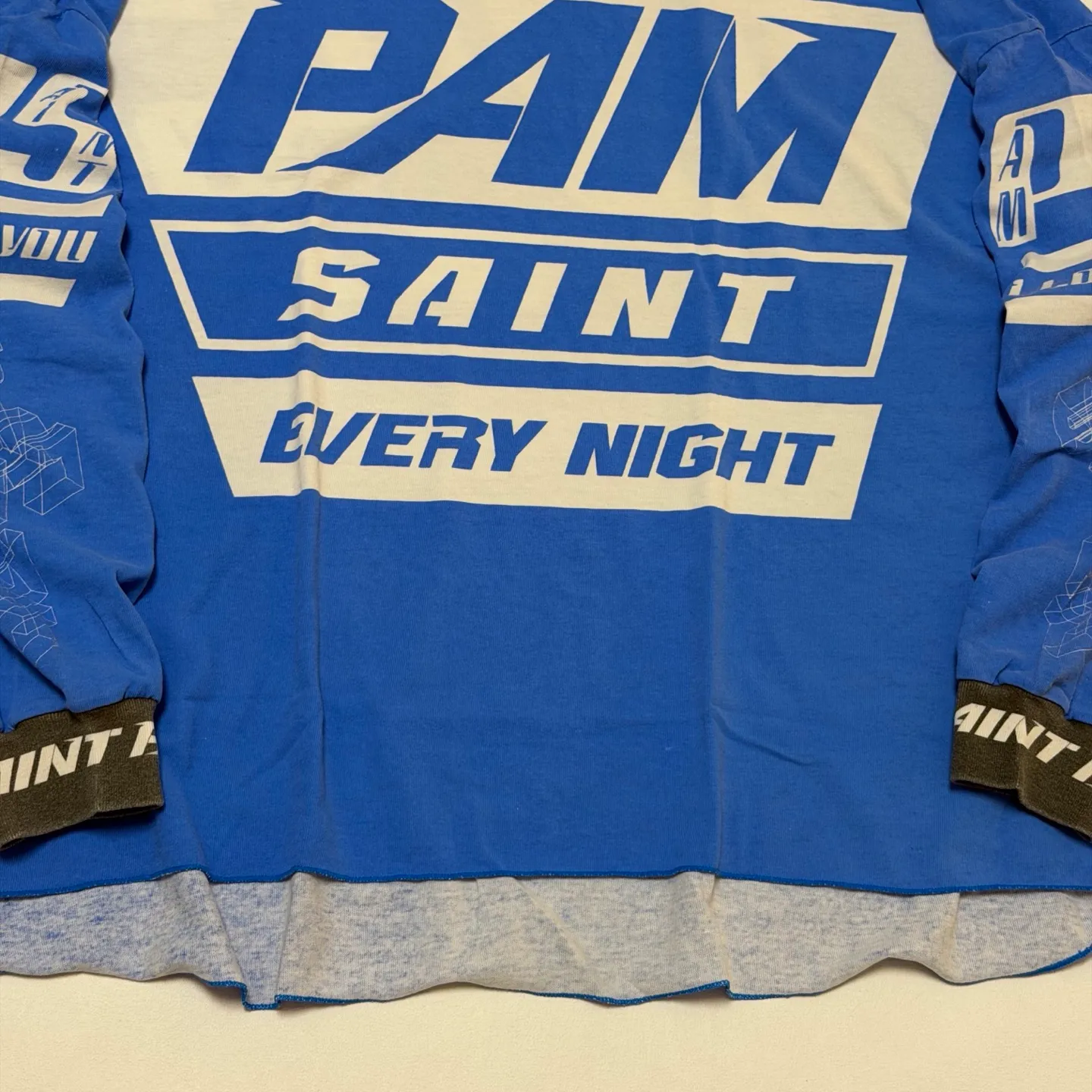 SAINT Mxxxxx Make the printing look distressed and white. Correct accessories. Customized co-branded model with P.A.M. wash mark.